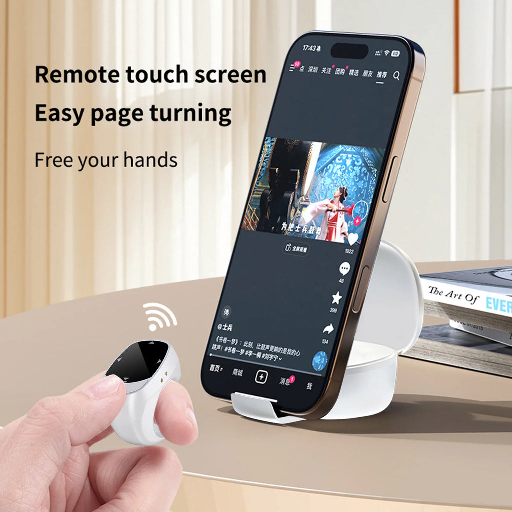 Comfortable fingertip remote being used as a wireless page turner for reading an e-book on a tablet